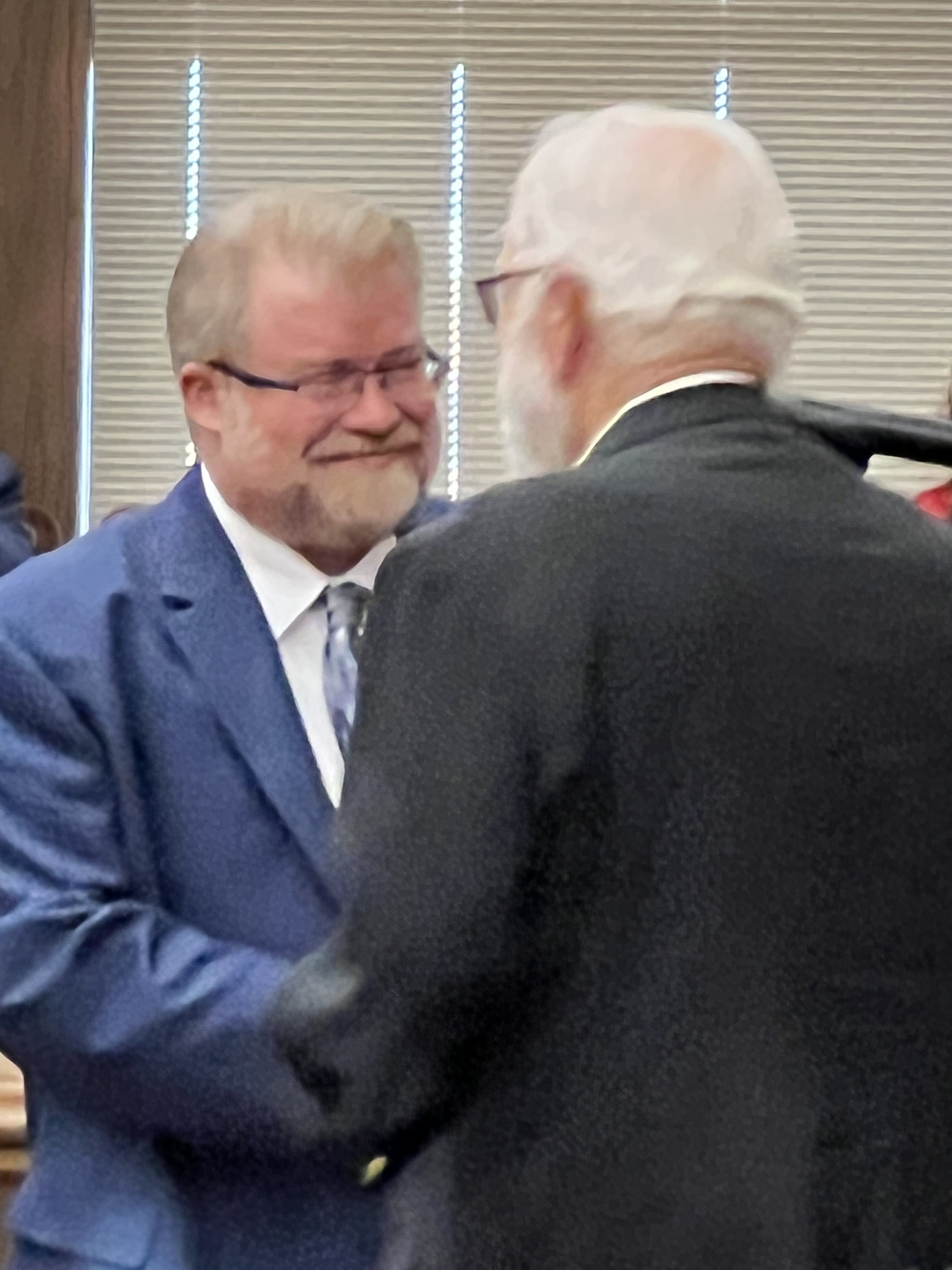 Commissioner David Shelton is sworn in to office by his father, former judge Wayne C. Shelton